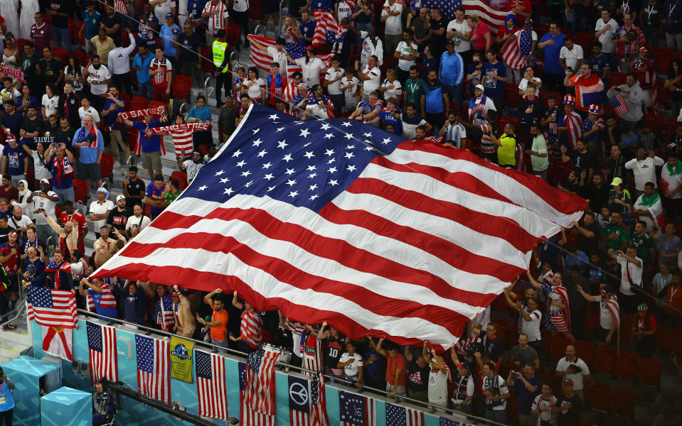 Soccer Football - FIFA World Cup Qatar 2022 - Group B - Iran v United States - Al Thumama Stadium, Doha, Qatar - November 29, 2022 Fans display a United States flag in the stands before the match REUTERS/Fabrizio Bensch