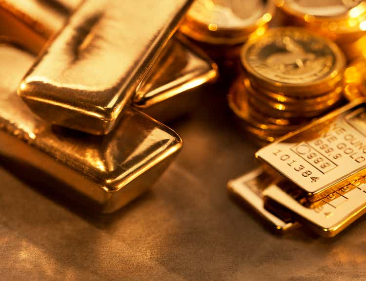 Gold ingots and coins close up